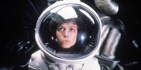 Ellen Ripley (Sigourney Weaver) in an astro<em></em>naut suit looking up in Alien 1979